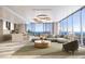 Expansive living room with floor-to-ceiling windows offering stunning water views and sophisticated decor at 235 1St S Ave # 2405, St Petersburg, FL 33701