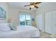Well-lit bedroom with city views from sliding glass doors, a ceiling fan, and neutral decor at 288 Beach Ne Dr # 12C, St Petersburg, FL 33701