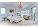 Bright bedroom featuring a light-colored chandelier and exterior balcony access with city views at 288 Beach Ne Dr # 12C, St Petersburg, FL 33701