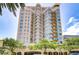 A stunning high-rise condo building with a light tan color and teal window trim is accented by curved balconies at 288 Beach Ne Dr # 12C, St Petersburg, FL 33701