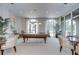 Large game room featuring a billiard table, carpeted floors, decorative lighting and beautiful outdoor views at 288 Beach Ne Dr # 12C, St Petersburg, FL 33701