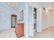 Hallway with stackable washer and dryer, cabinet, and a mirrored closet behind white louvered doors at 288 Beach Ne Dr # 12C, St Petersburg, FL 33701