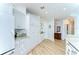 Bright and spacious kitchen with white cabinets, stainless steel appliances, and light wood flooring at 288 Beach Ne Dr # 12C, St Petersburg, FL 33701