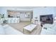 Spacious living room with tile floors, white sofas, modern coffee table, and bar seating to the kitchen at 288 Beach Ne Dr # 12C, St Petersburg, FL 33701