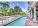 Outdoor pool with white baluster railing offers an amazing view of the green trees and city buildings at 288 Beach Ne Dr # 12C, St Petersburg, FL 33701