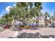 Inviting street view showcases a blend of retail, outdoor dining, mature trees, and landscaping at 288 Beach Ne Dr # 12C, St Petersburg, FL 33701