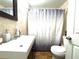 A bright bathroom with a modern vanity, a large mirror, and a shower with a stylish curtain at 3110 W Haya St, Tampa, FL 33614