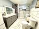 Modern bathroom with a glass-enclosed shower, tiled floor and vanity at 3110 W Haya St, Tampa, FL 33614