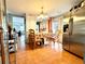 Dining room with stainless steel refrigerator, chandelier and adjoining living area at 3110 W Haya St, Tampa, FL 33614