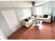 Cozy living room featuring a comfortable sofa, glass-top coffee table and tiled floor at 3110 W Haya St, Tampa, FL 33614