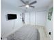 Bright bedroom offering light-colored floors, fan and closet space at 3120 Meadow Lake Ave, Largo, FL 33771