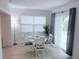 Cozy dining area with a round table, stylish curtains, and natural light at 3120 Meadow Lake Ave, Largo, FL 33771