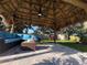 Inviting tiki hut with comfortable seating and a shaded retreat at 3120 Meadow Lake Ave, Largo, FL 33771
