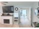 Bright living area featuring fireplace, large mirror, and open view to the dining space at 3120 Meadow Lake Ave, Largo, FL 33771