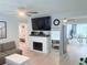Open-concept living room featuring a decorative fireplace and seamless flow to dining area at 3120 Meadow Lake Ave, Largo, FL 33771
