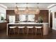 Modern kitchen with a large island, breakfast bar, and stylish pendant lighting fixtures at 324 Capri Blvd, Treasure Island, FL 33706