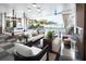 Stylish indoor-outdoor living space with a swing bed, modern furniture, and waterfront views at 324 Capri Blvd, Treasure Island, FL 33706