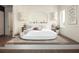 Serene main bedroom with a luxurious platform bed, stylish lamps, and cozy decor at 324 Capri Blvd, Treasure Island, FL 33706