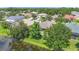 Aerial view of the neighborhood and home with its waterfront backyard, surrounded by lush trees at 3409 61St E Ter, Ellenton, FL 34222