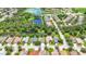 An aerial view of neighborhood homes with a picturesque pond and lush landscaping at 3409 61St E Ter, Ellenton, FL 34222