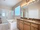 Luxurious bathroom featuring a soaking tub, walk-in shower, and dual vanity with granite countertops at 3409 61St E Ter, Ellenton, FL 34222
