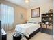 Comfortable bedroom featuring neutral walls, a ceiling fan, and a large window with sheer curtains at 3409 61St E Ter, Ellenton, FL 34222