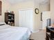 Cozy bedroom featuring a comfortable bed, built-in closet, and decorative shelving unit at 3409 61St E Ter, Ellenton, FL 34222