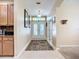 Foyer with white tile flooring, neutral colored walls, and a white framed glass panel entry door at 3409 61St E Ter, Ellenton, FL 34222