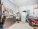 Organized garage featuring a work bench, storage solutions, and a motorcycle for hobbyists at 3409 61St E Ter, Ellenton, FL 34222