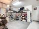 Spacious garage with storage shelving, overhead lighting, and ample room for a workout area at 3409 61St E Ter, Ellenton, FL 34222