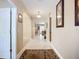 Bright hallway with tile flooring, arched doorways, and decorative wall art leading to other rooms at 3409 61St E Ter, Ellenton, FL 34222