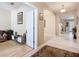Open hallway featuring tile and wood floors, arched doorway, and views into the living spaces at 3409 61St E Ter, Ellenton, FL 34222