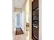Hallway showing access to multiple rooms in the home, including a view into the living room and kitchen at 3409 61St E Ter, Ellenton, FL 34222
