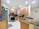 Well-equipped kitchen with stainless steel appliances, granite countertops and wood cabinets at 3409 61St E Ter, Ellenton, FL 34222