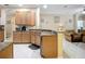 Open kitchen with ample counter space and wood cabinets, blending into the living area at 3409 61St E Ter, Ellenton, FL 34222