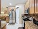 Open-concept kitchen featuring stainless steel appliances and wooden cabinets at 3409 61St E Ter, Ellenton, FL 34222