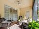 Cozy lanai featuring stylish furniture, ceiling fan, and shuttered windows for added privacy at 3409 61St E Ter, Ellenton, FL 34222