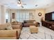 Bright and airy living room featuring plantation shutters, a cozy seating arrangement, and stylish decor at 3409 61St E Ter, Ellenton, FL 34222