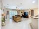 Open-concept living room with tile flooring, neutral walls, and a ceiling fan at 3409 61St E Ter, Ellenton, FL 34222
