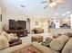 Comfortable living room featuring neutral tones, ceiling fan, and an open layout flowing into the kitchen at 3409 61St E Ter, Ellenton, FL 34222