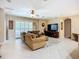 Bright living room with large windows, comfortable seating, and entertainment center at 3409 61St E Ter, Ellenton, FL 34222
