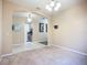 Neutral carpeted living room, arched doorway, a chandelier, and neutral colored walls at 3409 61St E Ter, Ellenton, FL 34222