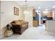 Cozy living room area boasts tile floors and comfortable seating adjacent to the kitchen at 3409 61St E Ter, Ellenton, FL 34222