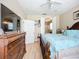Comfortable main bedroom features wood floors, ceiling fan, and decorative wooden furniture at 3409 61St E Ter, Ellenton, FL 34222