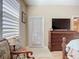 Bright main bedroom featuring plantation shutters, wood floors, and access to the ensuite bathroom at 3409 61St E Ter, Ellenton, FL 34222