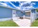 Exterior view of home with a patio and paved walkway; backyard complete with a fence at 35014 Carl Ave, Zephyrhills, FL 33541