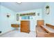 Bedroom with wood furniture including dresser and vanity; a window provides natural light to the cozy space at 35014 Carl Ave, Zephyrhills, FL 33541