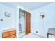 Modest bedroom with wood dresser and closet; lamp provides soft lighting, creating a peaceful retreat at 35014 Carl Ave, Zephyrhills, FL 33541