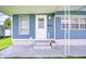 Welcoming entrance with a white door, complemented by vibrant flowers and fresh paint at 35014 Carl Ave, Zephyrhills, FL 33541