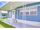 Charming entrance with a covered porch, freshly painted door, and stylish railing at 35014 Carl Ave, Zephyrhills, FL 33541